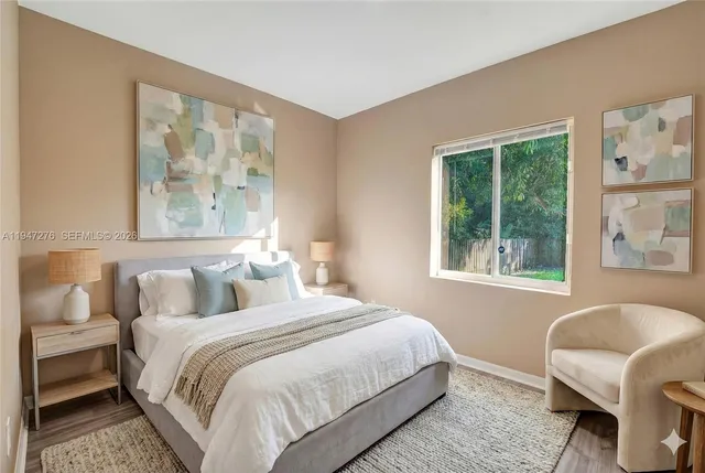 a bedroom with a bed and a large window