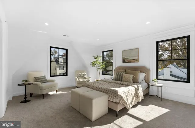 a bedroom with a bed and a large window