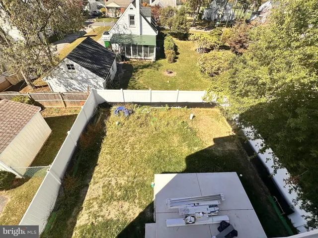 view of a balcony with floor to ceiling windows and wooden fence