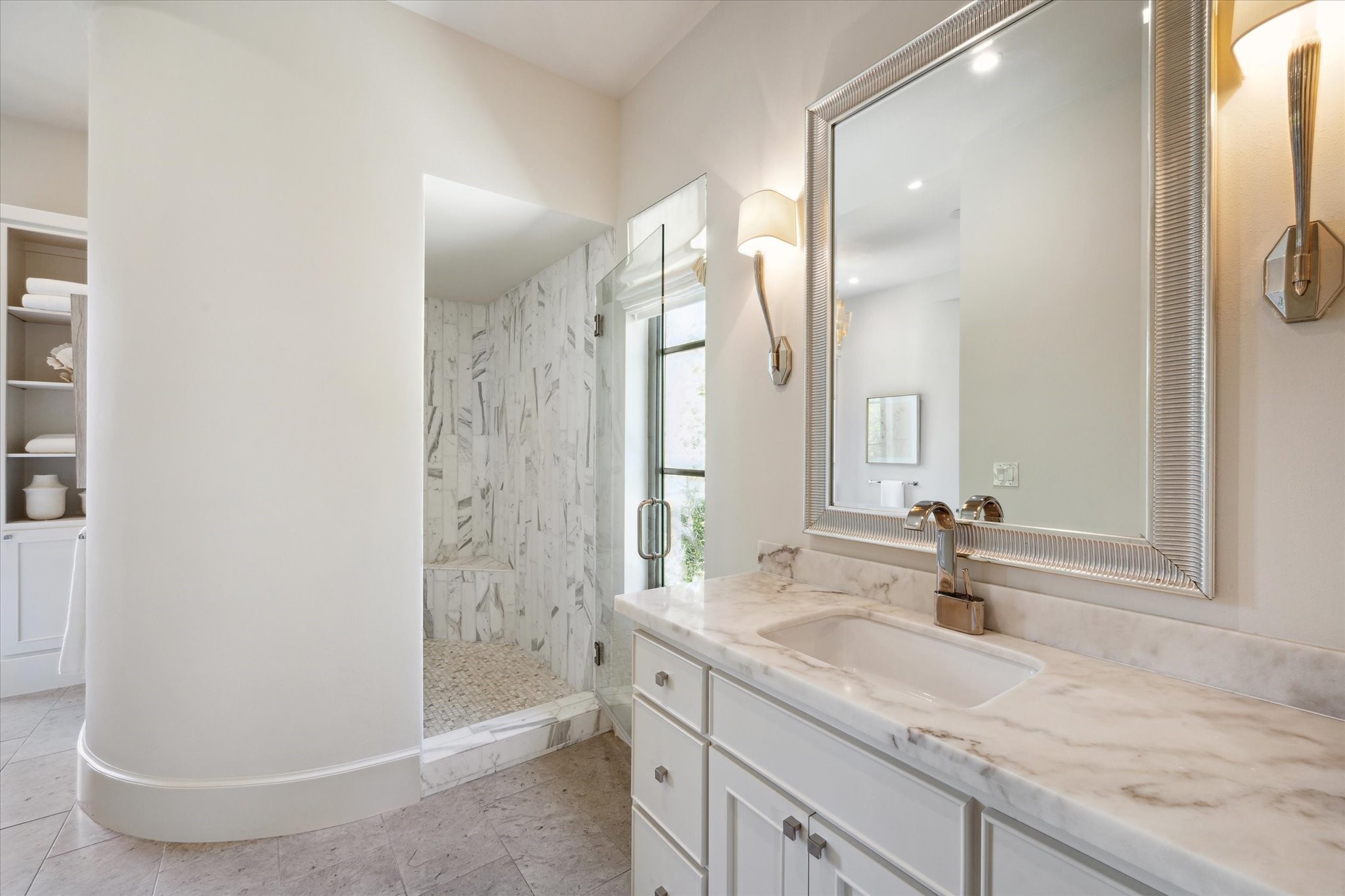 633 Quintana Roo Place Seabrook, TX 77586 - Photo 24 of 47 The primary en suite bathroom is reminiscent of a Roman bath, with stately marble and soothing rounded walls.