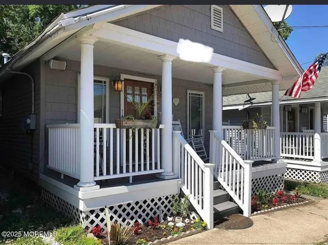 a view of a brick house with wooden fence