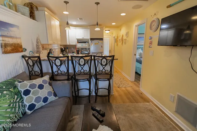 a view of a dining room with furniture and kitchen view