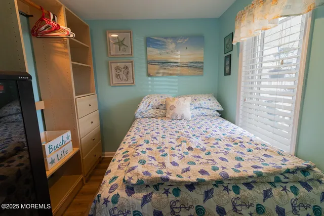 a bedroom with a bed and painting on the wall
