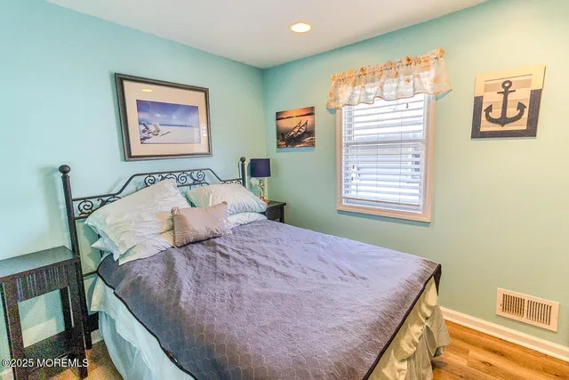 a bed sitting in a bedroom next to a window