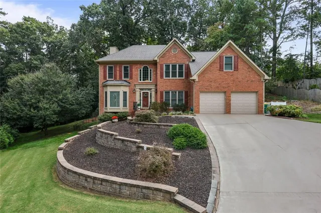 a front view of house with yard and green space