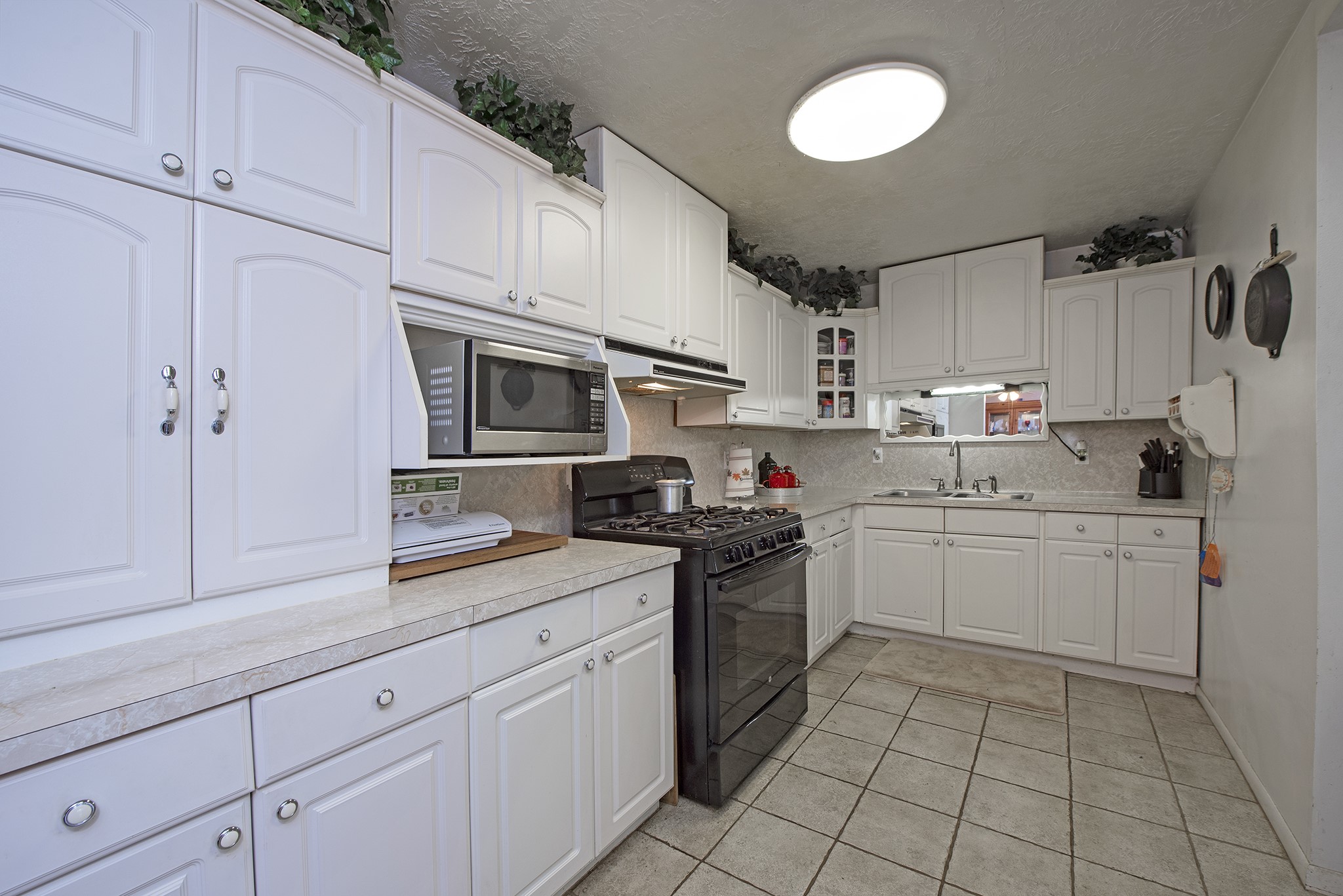 22234 Castle Road Waller, TX 77484 - Photo 22 of 50 a kitchen with cabinets stainless steel appliances and sink