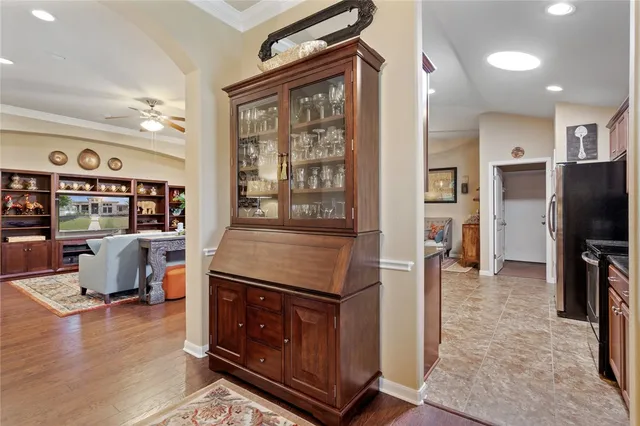 a kitchen with sink a stove and chairs