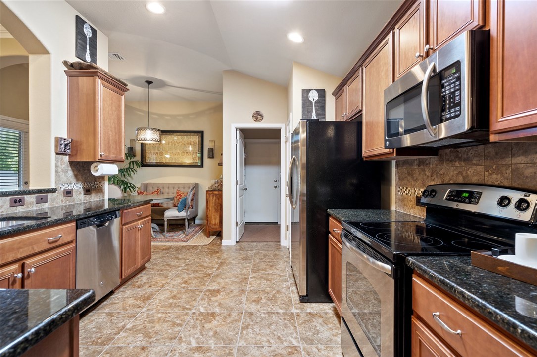 1901 Discovery Boulevard Cedar Park, TX 78613 - Photo 18 of 40 a kitchen with stainless steel appliances granite countertop a stove refrigerator and a sink
