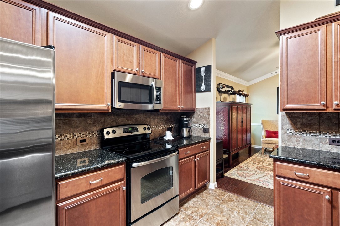 1901 Discovery Boulevard Cedar Park, TX 78613 - Photo 22 of 40 a kitchen with stainless steel appliances granite countertop a refrigerator stove and microwave