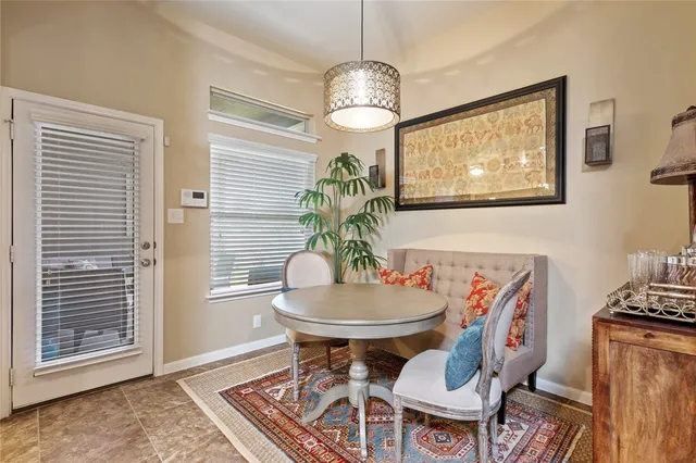 a dining room with furniture a chandelier and wooden floor