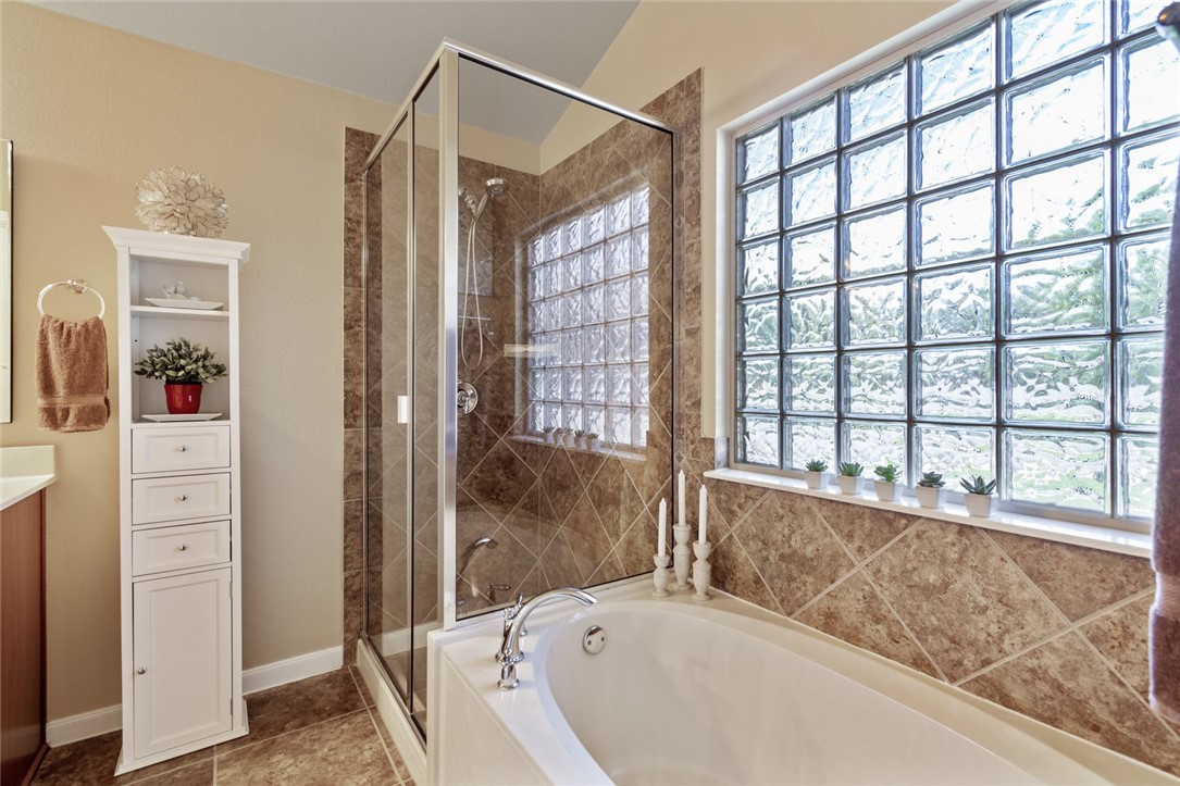 1901 Discovery Boulevard Cedar Park, TX 78613 - Photo 30 of 40 a bathroom with a bathtub and a shower