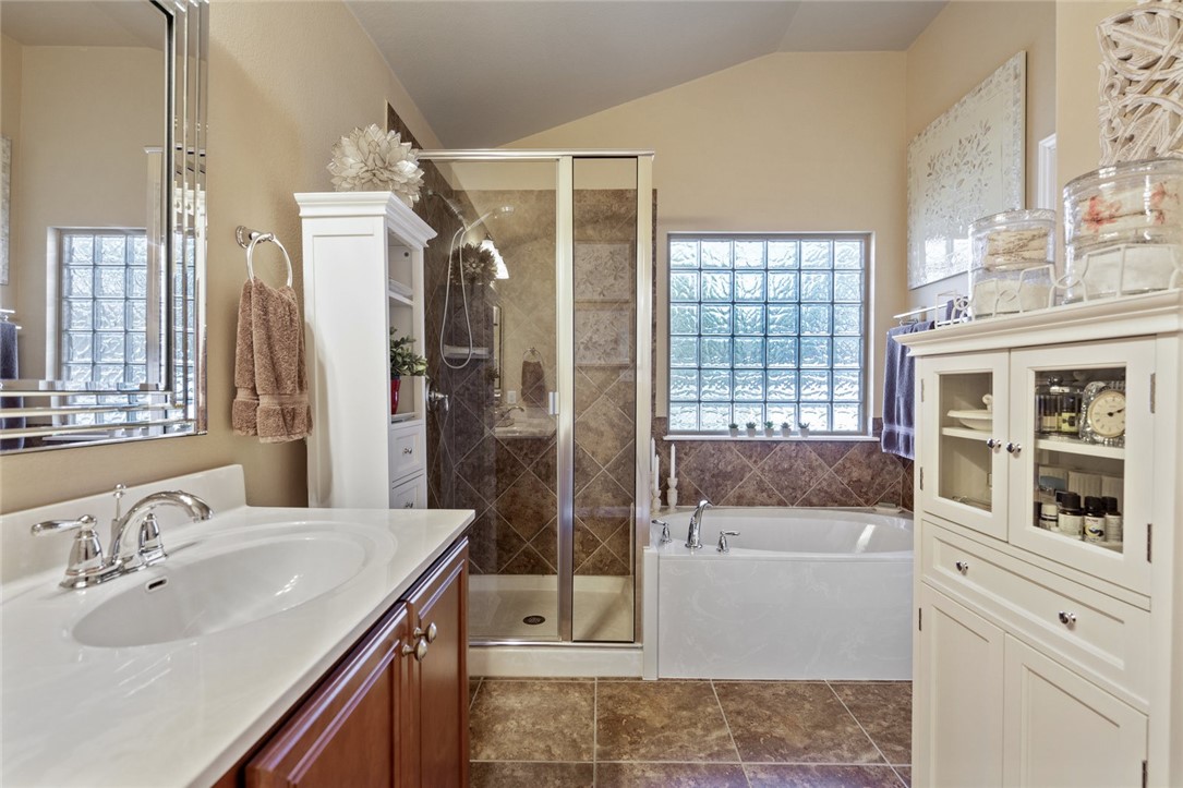 1901 Discovery Boulevard Cedar Park, TX 78613 - Photo 33 of 40 a bathroom with a tub sink and mirror