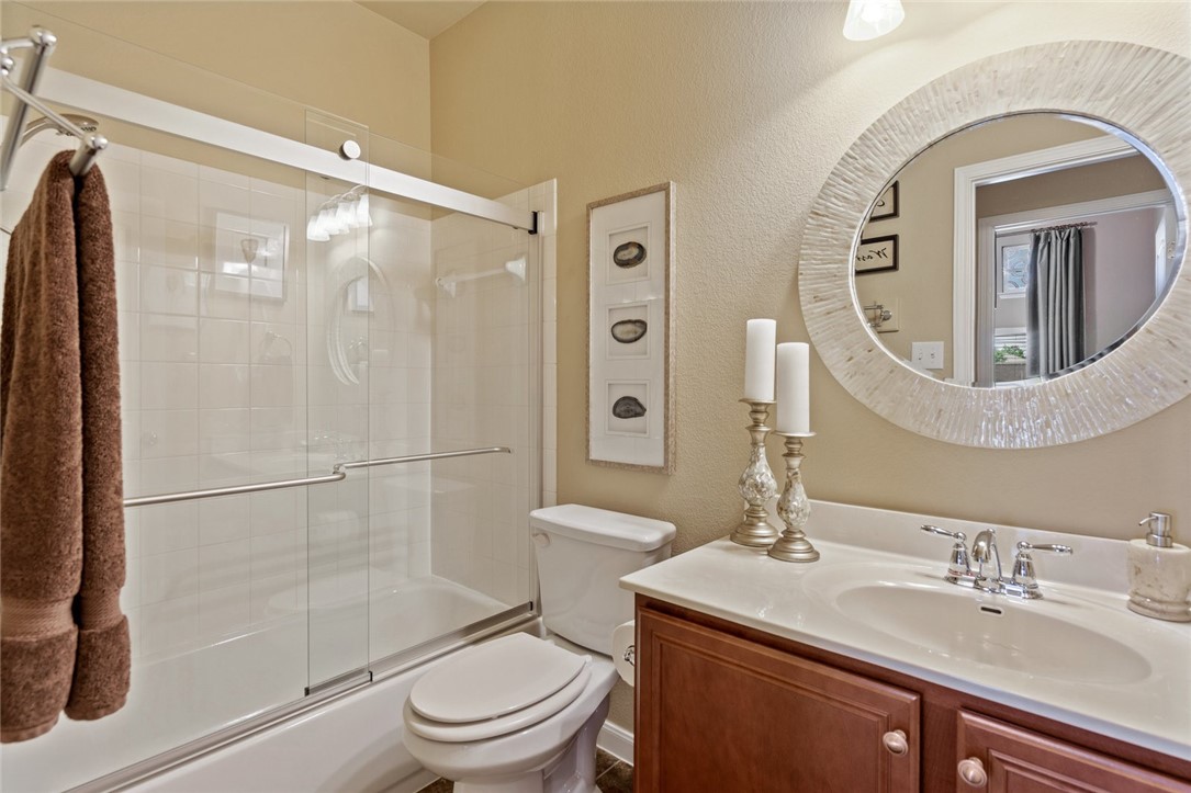 1901 Discovery Boulevard Cedar Park, TX 78613 - Photo 36 of 40 a bathroom with a toilet a sink and glass door