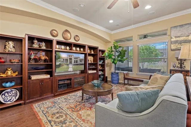 a living room with furniture and a book shelf