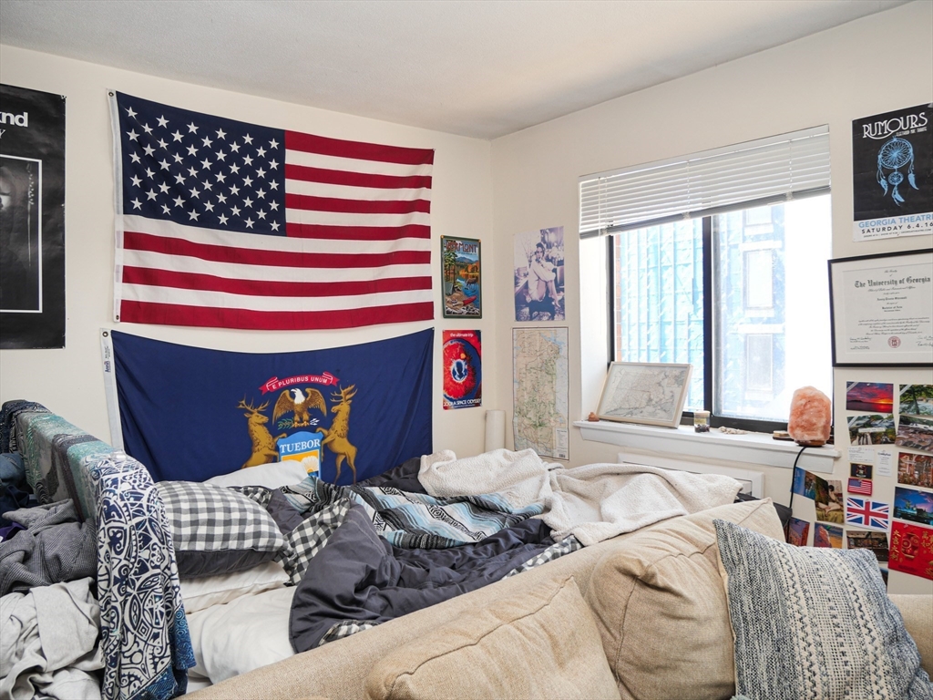 1027 Commonwealth Avenue, Unit 33 Boston, MA 02215 - Photo 2 of 4 a bedroom with furniture and a window