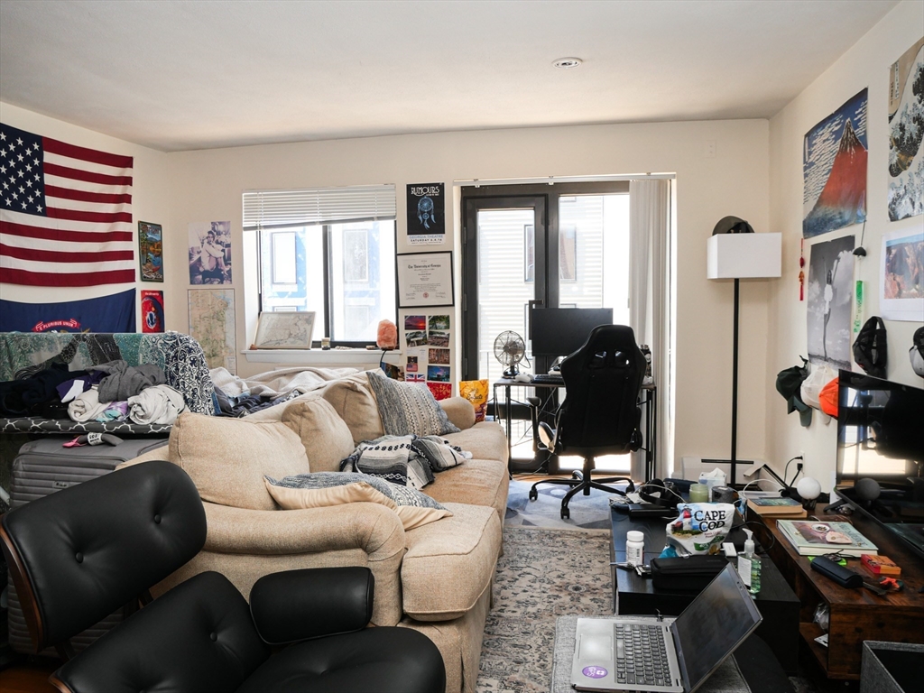 1027 Commonwealth Avenue, Unit 33 Boston, MA 02215 - Photo 3 of 4 a living room with furniture and wooden floor
