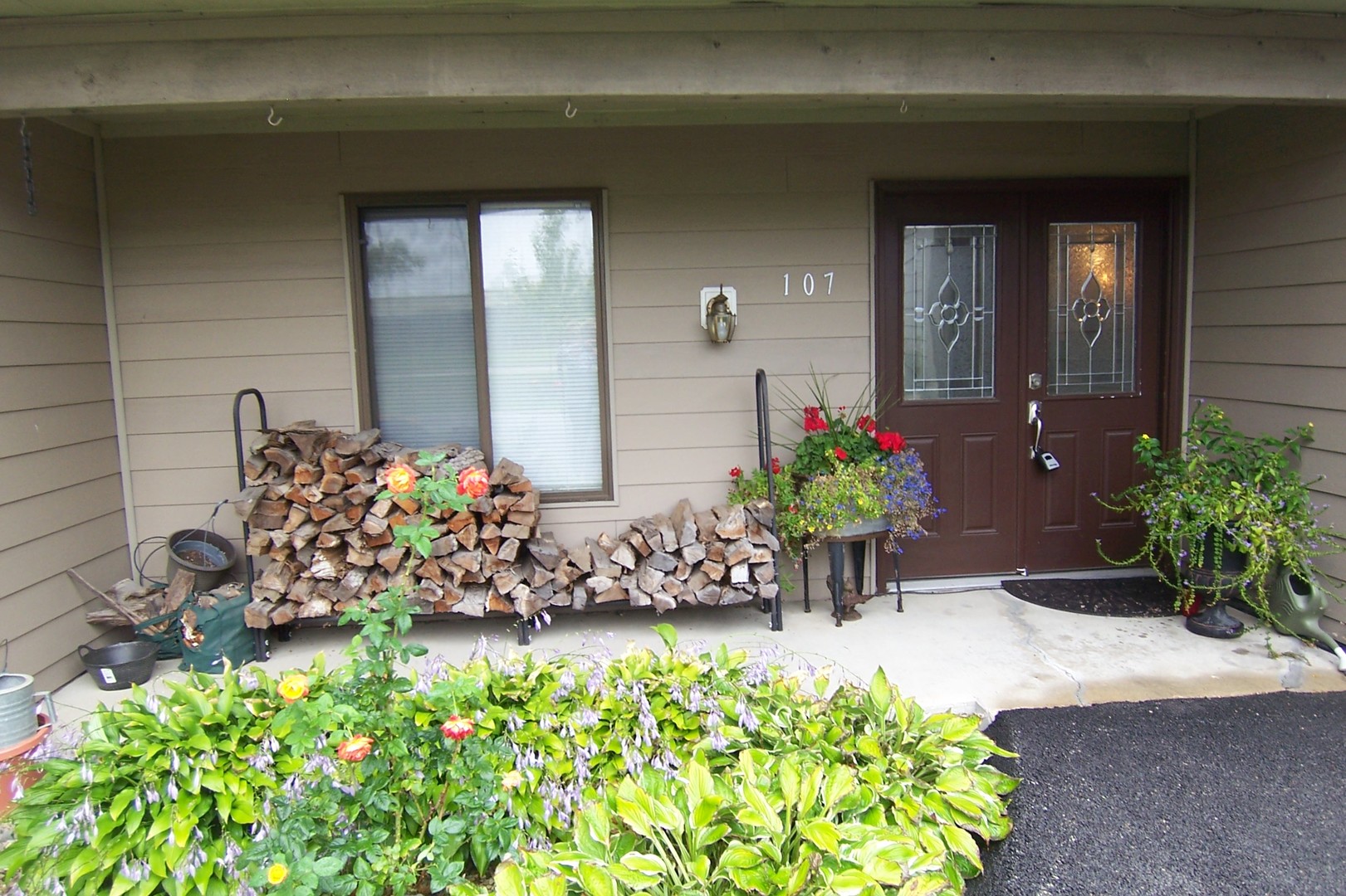 a front view of a house with a lot of flowers