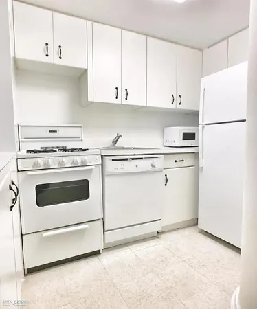 a kitchen with cabinets appliances and a sink