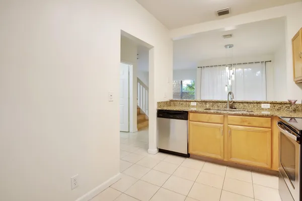 a kitchen with granite countertop white cabinets and white appliances