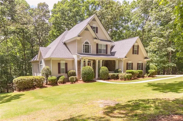a front view of house with yard outdoor seating and barbeque oven