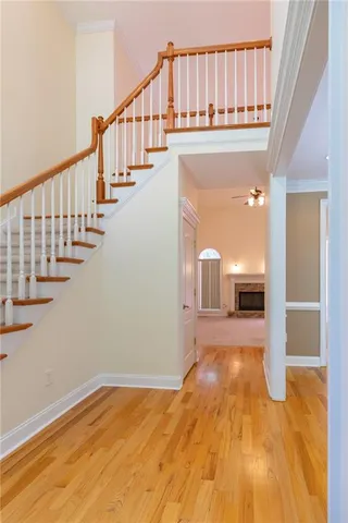 a view of entryway and hall with wooden floor