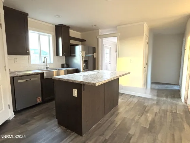 a kitchen with a sink a counter top space and cabinets
