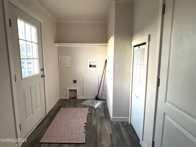 a view of a hallway with wooden floor and a livingroom