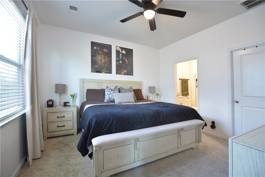 242 Hillendale Way Pelzer, SC 29669 - Photo 14 of 19 This spacious bedroom offers ample comfort and direct access to a private bathroom.