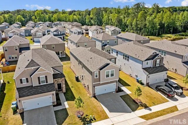 an aerial view of a house with a big yard