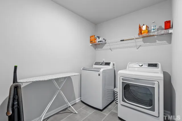 a spacious bedroom with a bed and a dresser