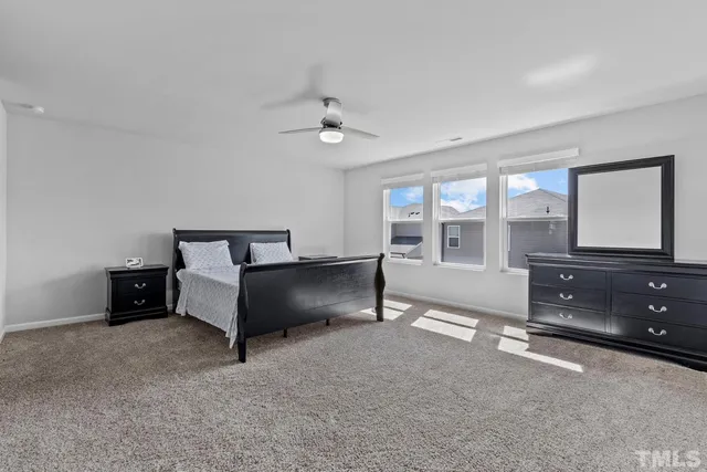 a bedroom with a bed lamp and window