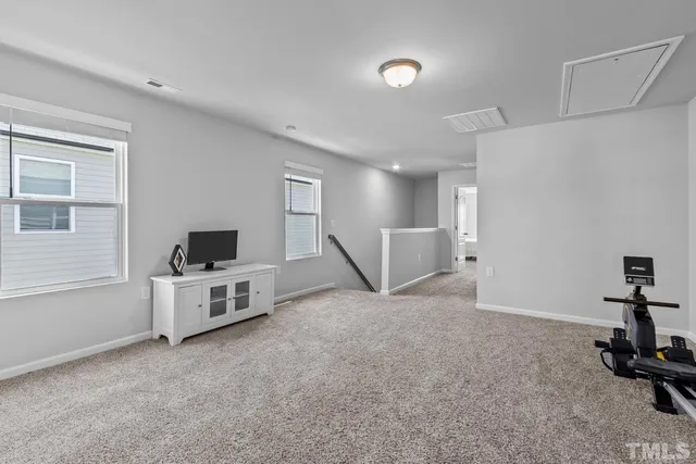 a view of walk in closet with clothes