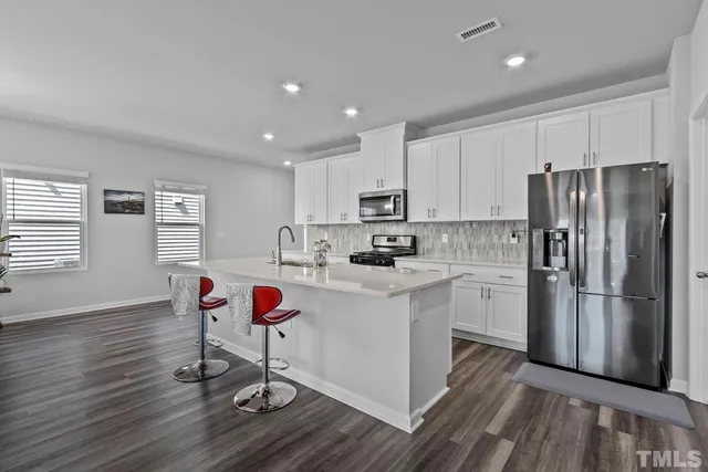 a kitchen with sink and natural light