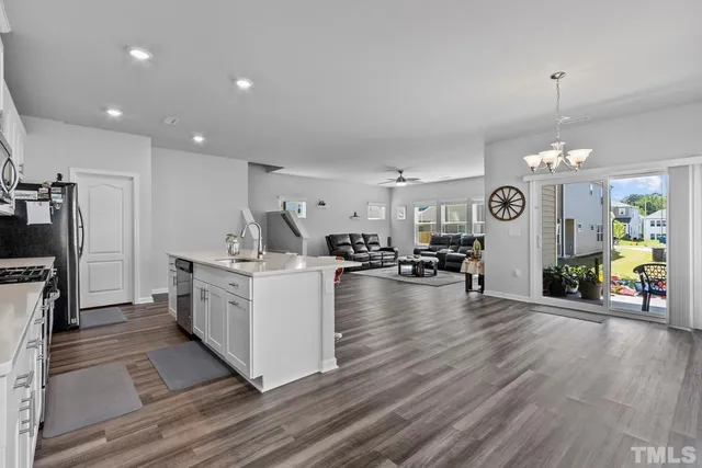 a kitchen with microwave a stove and cabinets