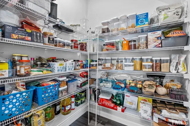 a living room with furniture ceiling fan and a wooden floor