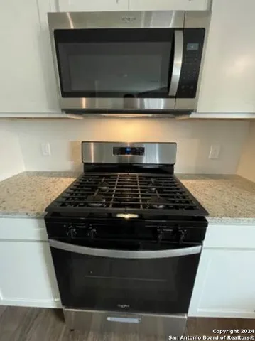 a stove top oven sitting inside of a kitchen