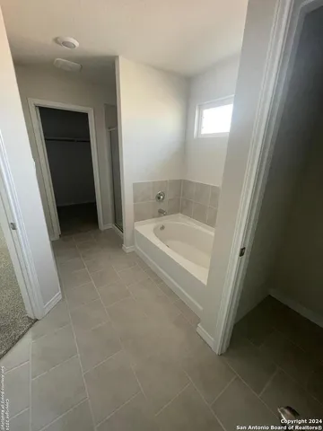 a bathroom with a bathtub and a sink