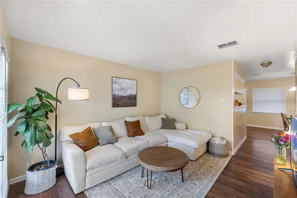 a living room with furniture and a lamp