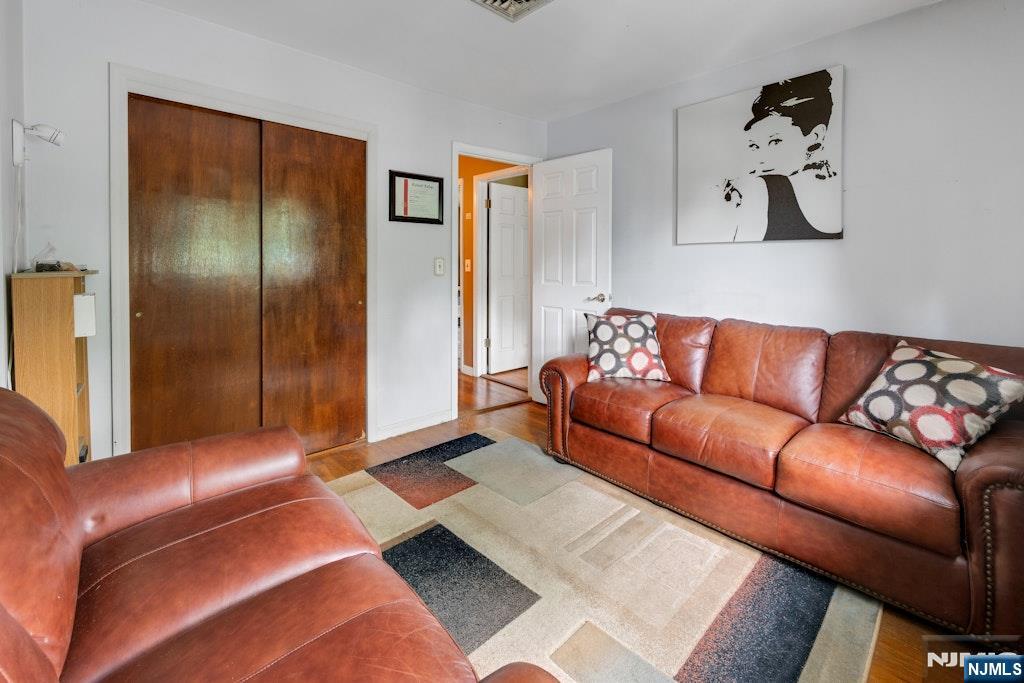 185 Ratzer Road Wayne, NJ 07470 - Photo 27 of 36 a blue couch sitting in a living room with a lamp