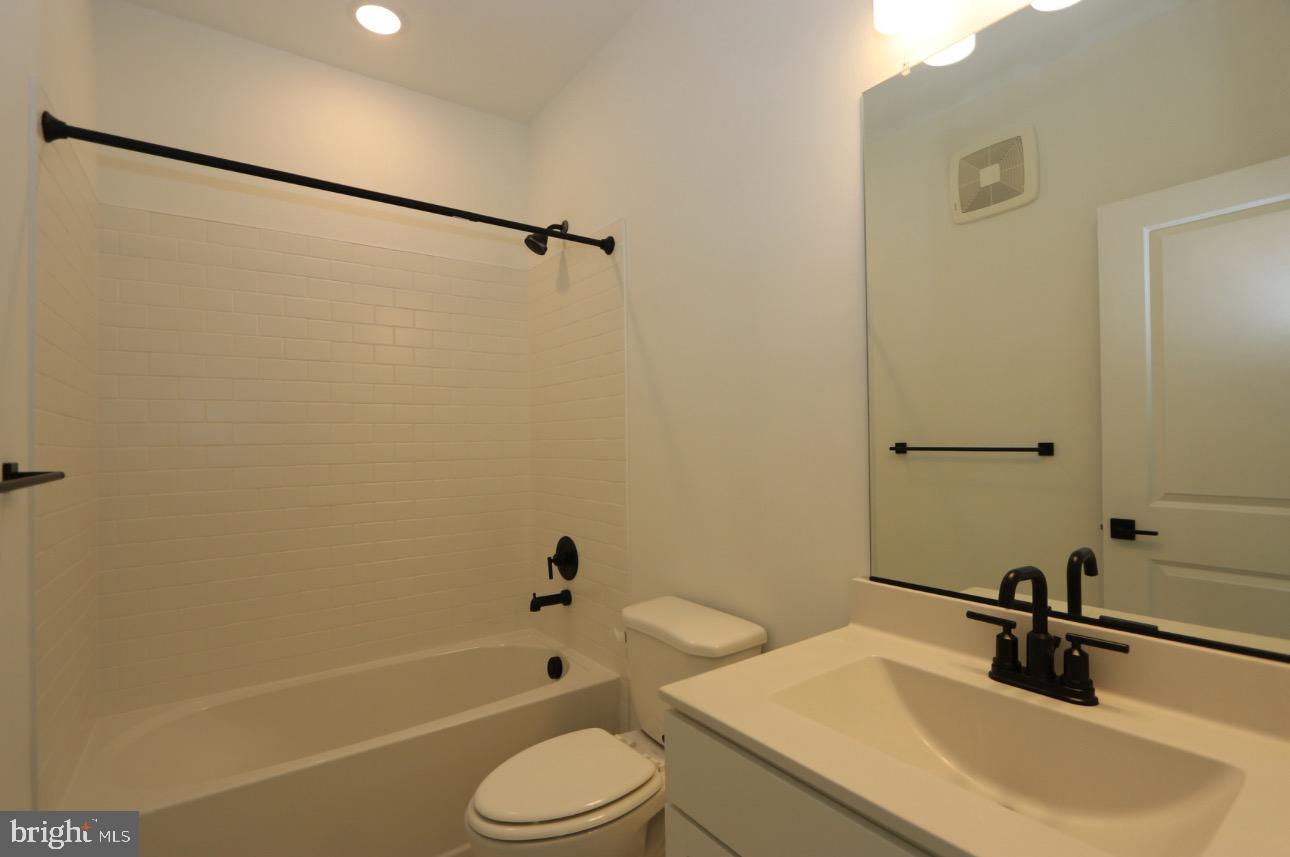 117 East Cromwell Street, Unit A Baltimore, MD 21230 - Photo 15 of 35 a bathroom with a sink a toilet and a bathtub