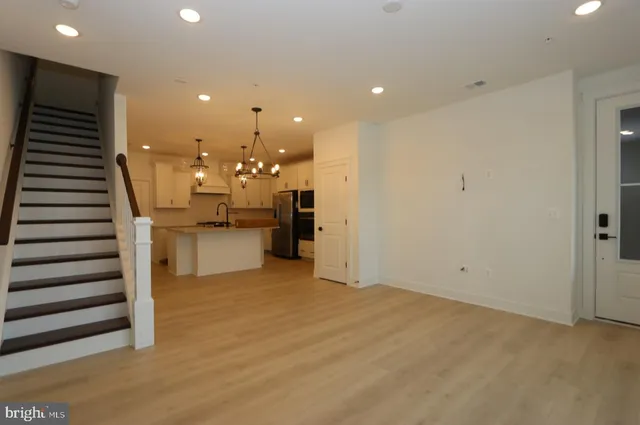 a view of a kitchen with cabinets and stainless steel appliances