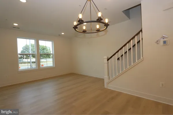 en view interior of a house with wooden floor windows and a chandelier