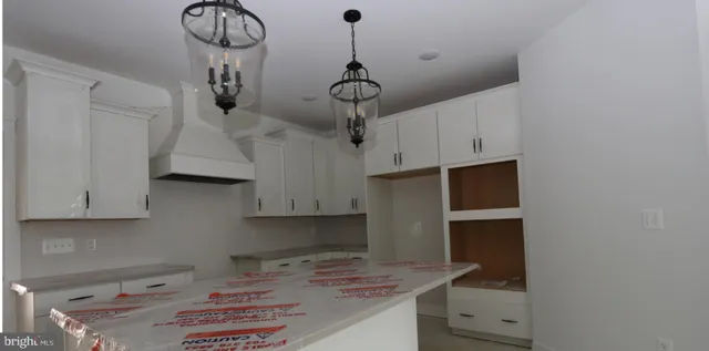 a kitchen with stainless steel appliances a stove a refrigerator and cabinets