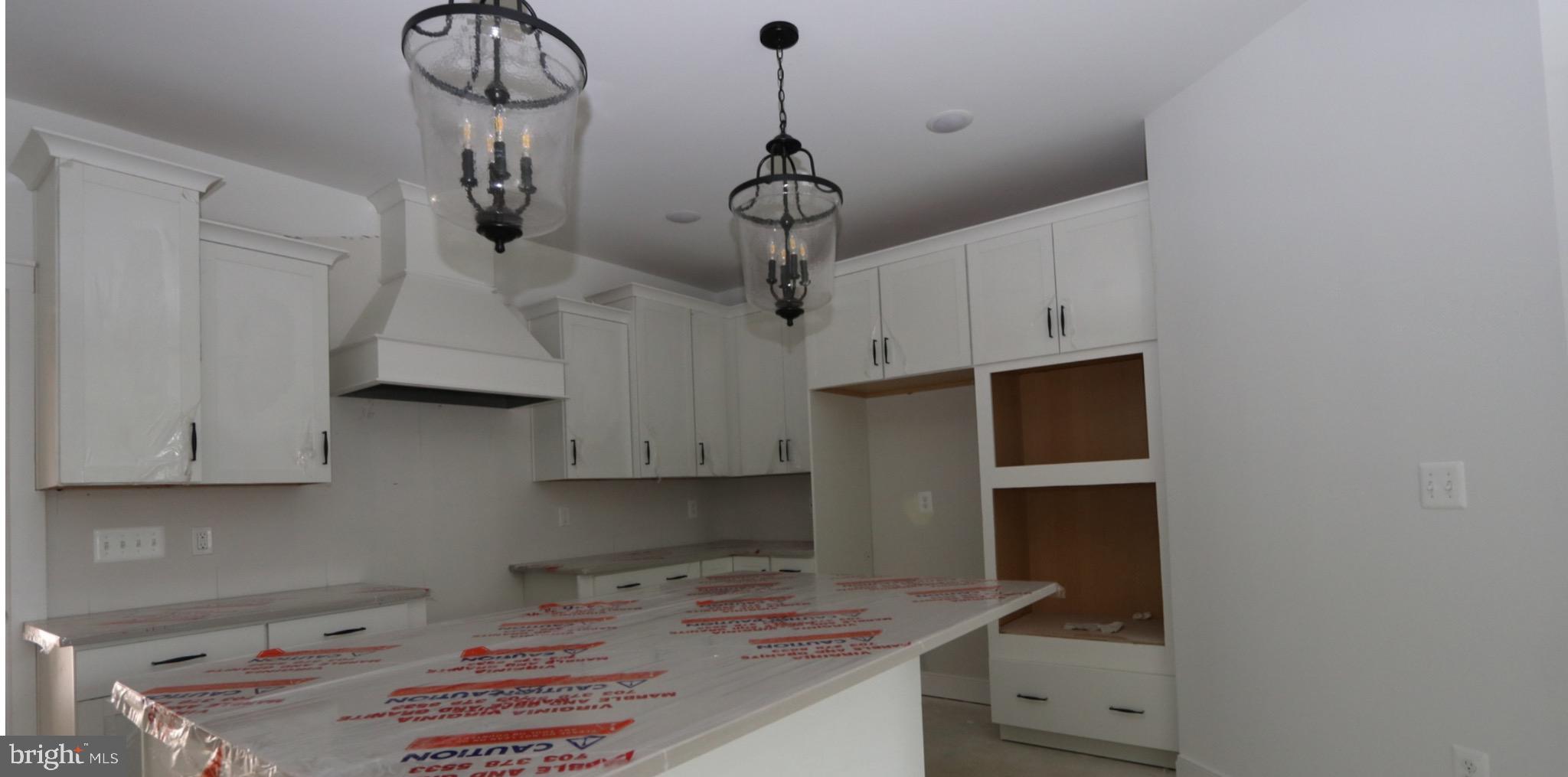 117 East Cromwell Street, Unit A Baltimore, MD 21230 - Photo 28 of 35 a kitchen with stainless steel appliances a stove a refrigerator and cabinets