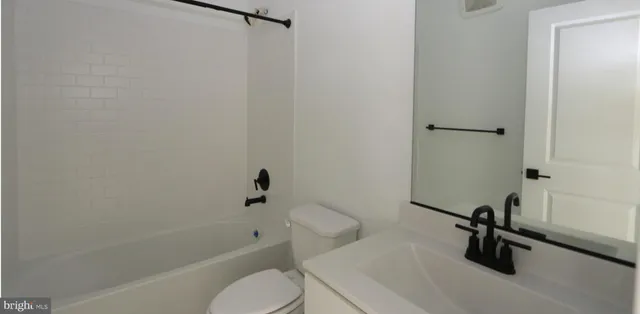 a bathroom with a sink a toilet and a bathtub
