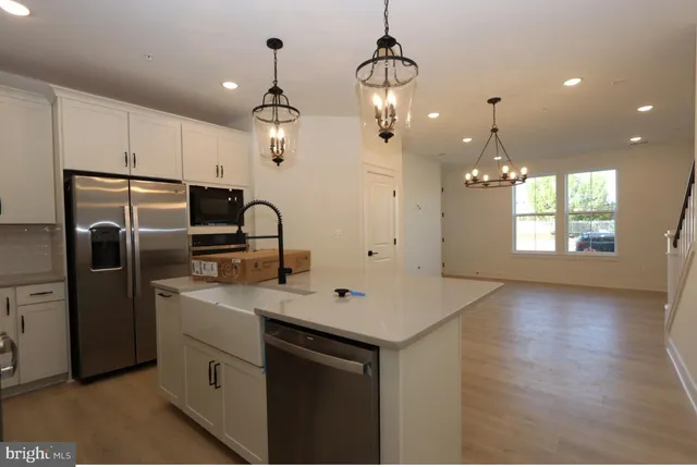 a kitchen with refrigerator cabinets and wooden floor