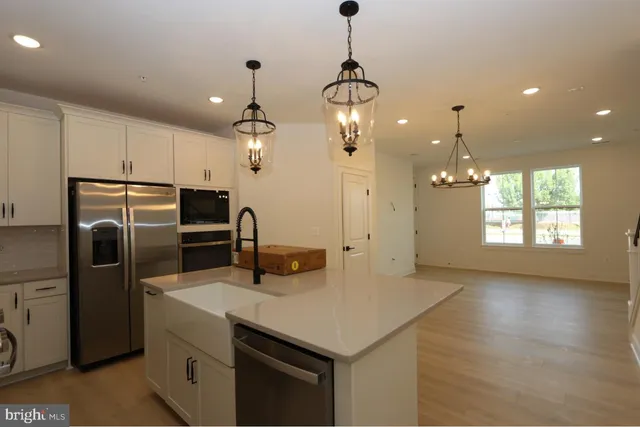 a kitchen with refrigerator and windows