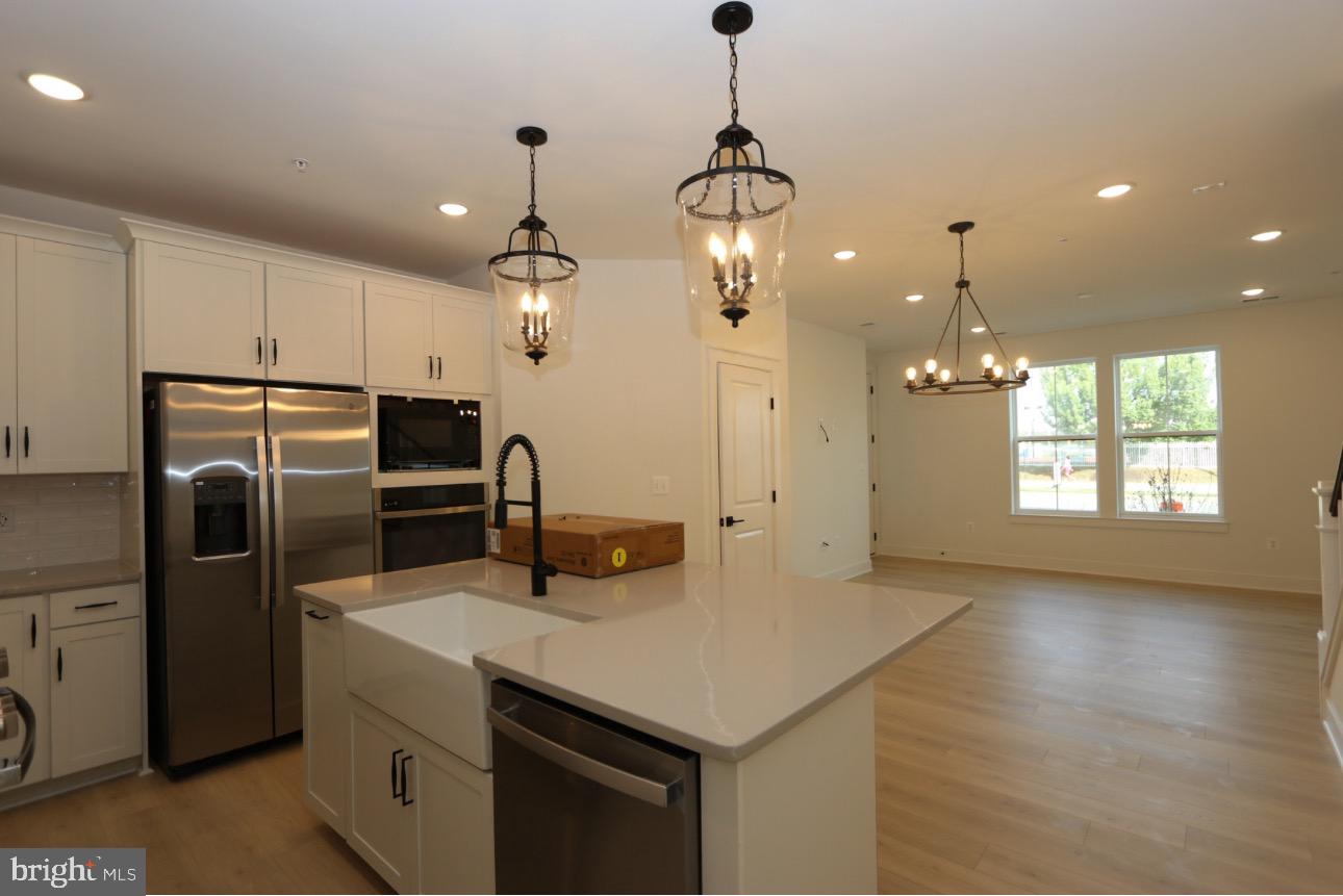 117 East Cromwell Street, Unit A Baltimore, MD 21230 - Photo 5 of 35 a kitchen with refrigerator and windows