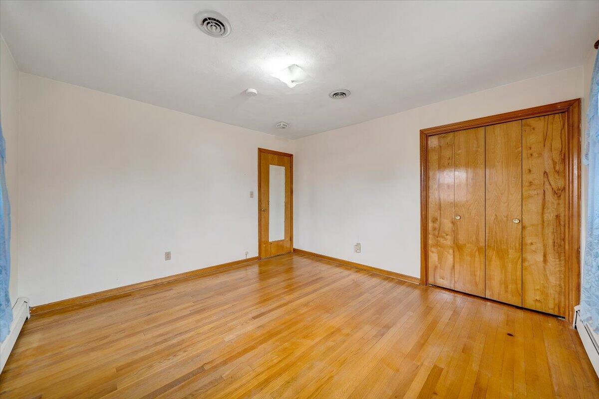626 Santee Road Roanoke, VA 24019 - Photo 19 of 56 a view of an empty room with wooden floor and a window