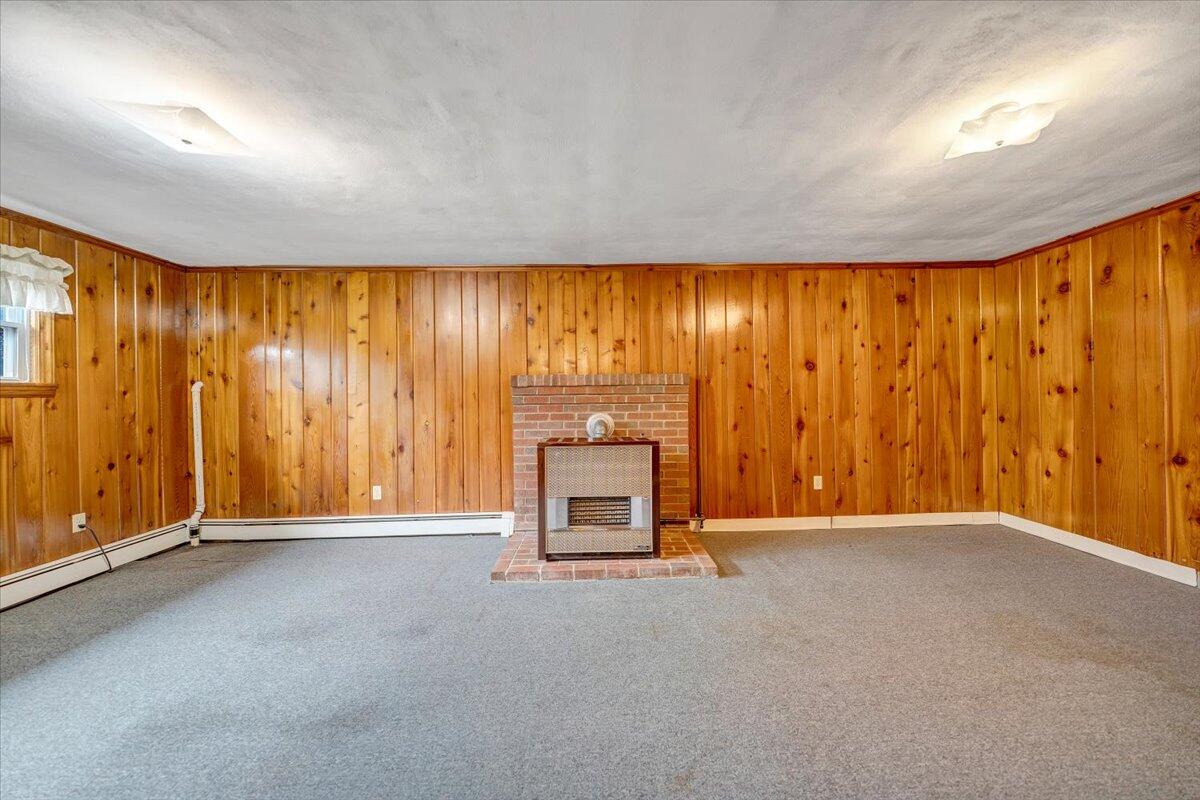 626 Santee Road Roanoke, VA 24019 - Photo 26 of 56 a view of an empty room with a fireplace and a window